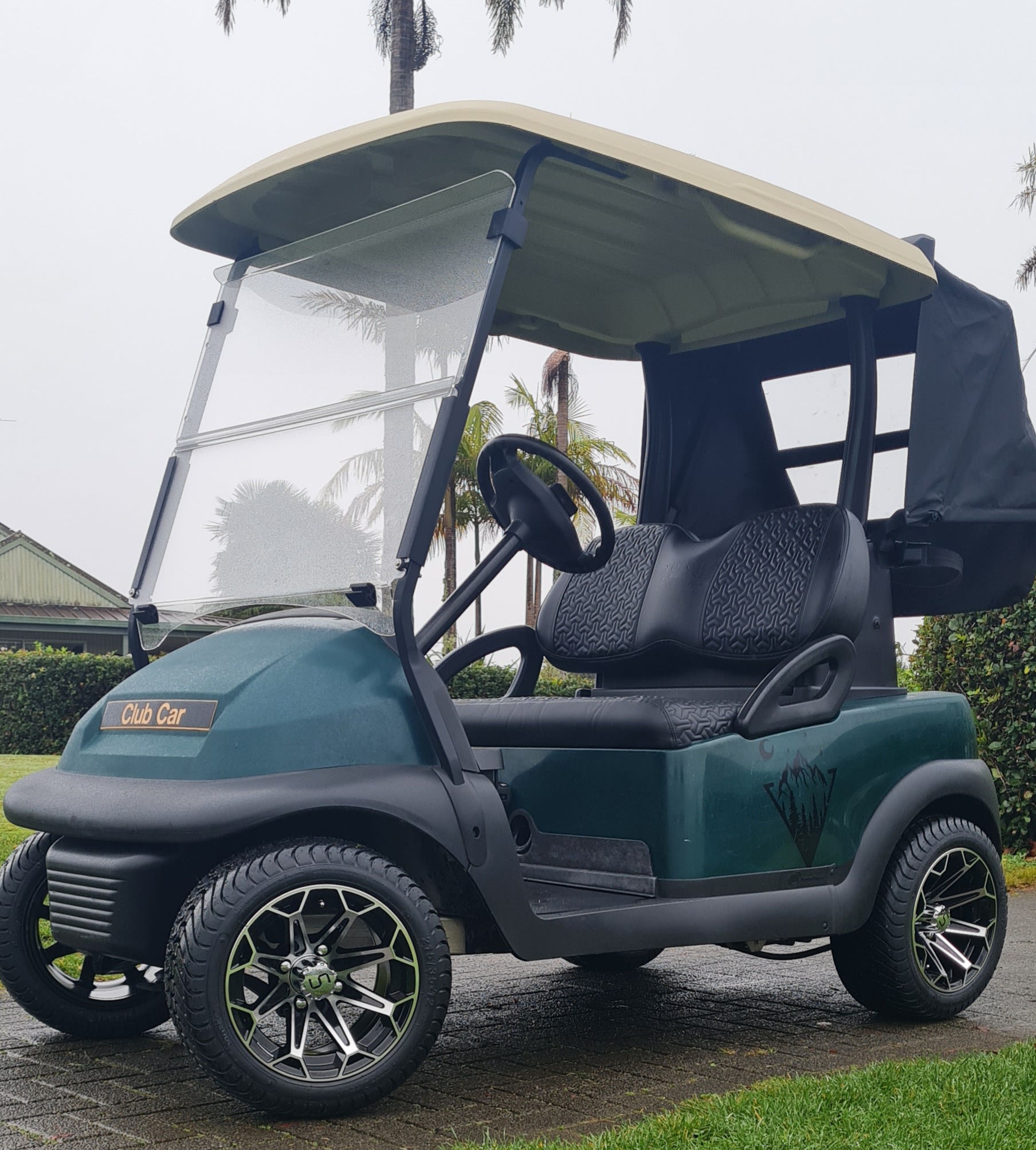 Dark green Club Car Precedent golf cart with black mag wheels
