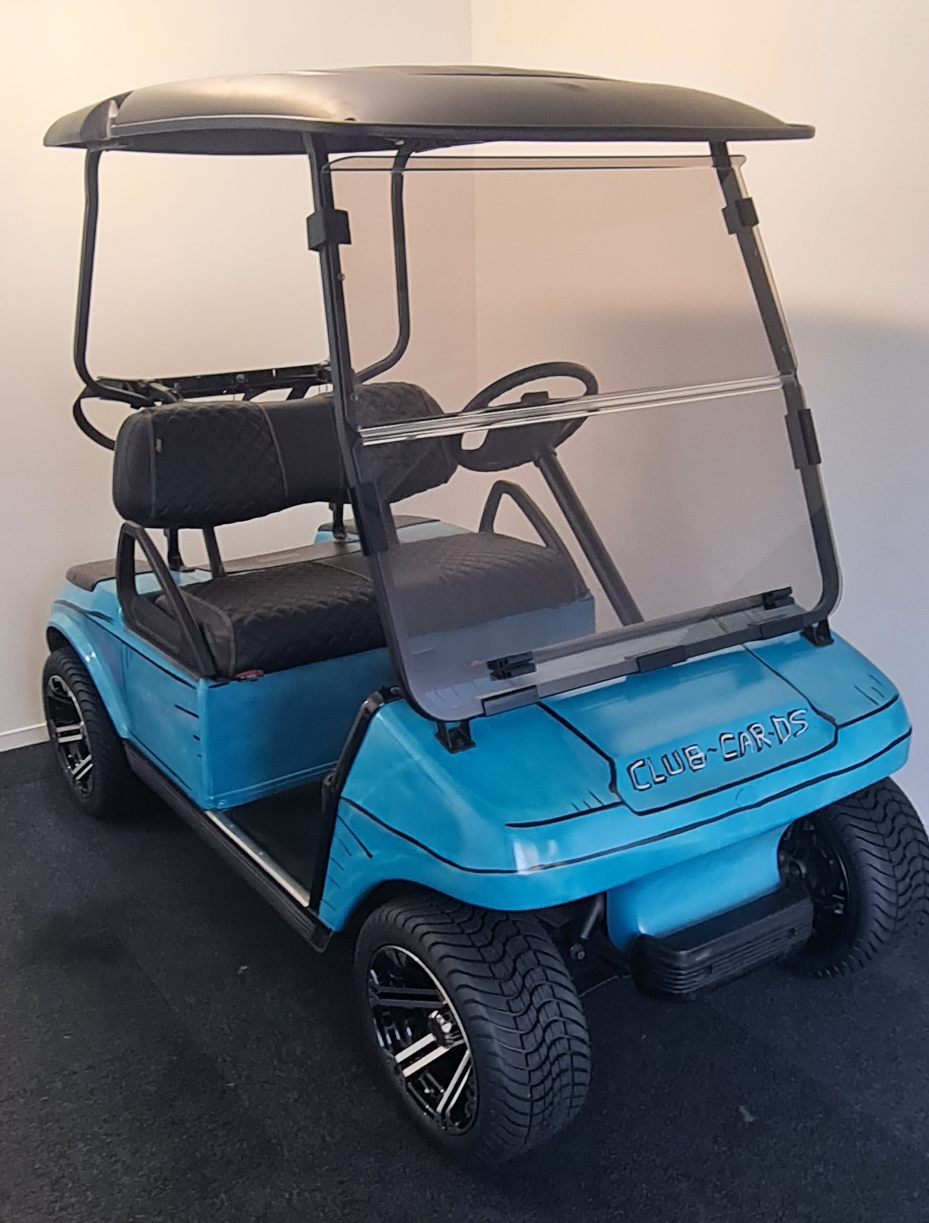 Fully restored blue Club Car DS golf cart with black seats and mag wheels